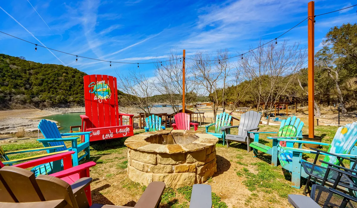 Fire pit area with colorful Adirondack chairs